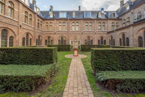 a large brick building with a brick pathway in front of it at LOFT d'O in Ypres