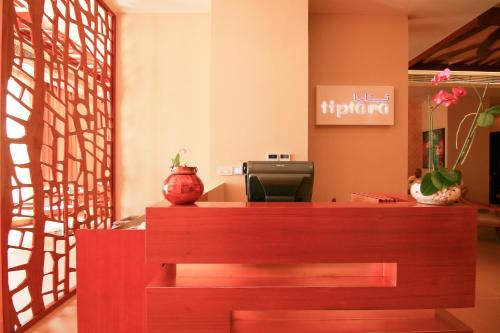 a cashier counter in a store with a vase at Centara Muscat Hotel Oman in Muscat