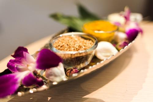a plate with a bowl of food on a table at Centara Muscat Hotel Oman in Muscat