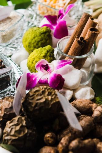 a table topped with different types of rocks and flowers at Centara Muscat Hotel Oman in Muscat