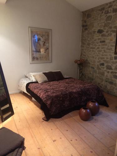 - une chambre avec un lit assise sur du parquet dans l'établissement Ancienne tonnellerie, à Gallargues-le-Montueux