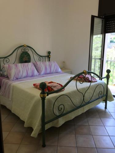 um quarto com uma cama com um edredão branco em Casetta Porta Riore - Sonnino casa vacanze em Sonnino