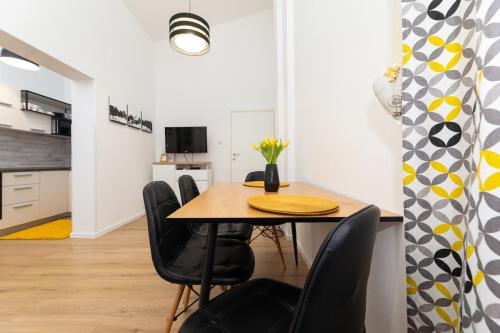 a dining room with a table and chairs at Apartments Frgacic I in Baška