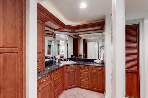a bathroom with a sink and a large mirror at Knott Lakeview in Bass Lake