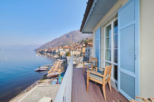 a balcony of a house with a view of the water at Hotel Villa Aurora in Lezzeno