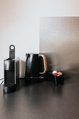 a coffee maker and a phone on a counter at Vida Verde in Valkenburg