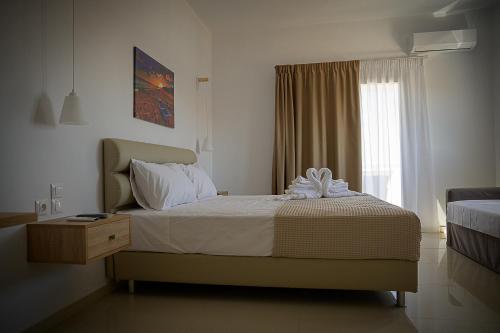 a hotel room with a bed and a window at SunSea Studios close to the beach in Kato Gouves