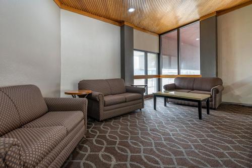 a waiting room with two couches and a table at Suburban Studios Lafayette in Lafayette