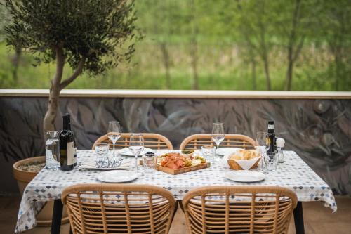 a table with a basket of food and wine bottles at Ponte Porton Dining & lodging in Grožnjan