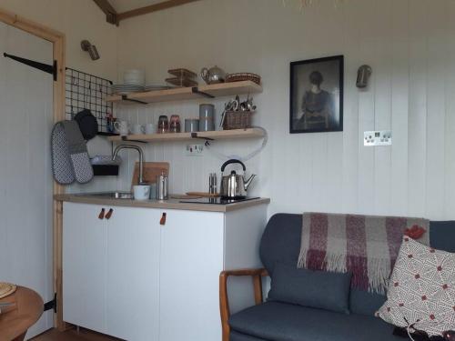 a kitchen with a counter and a couch in a room at Doris in Wedmore