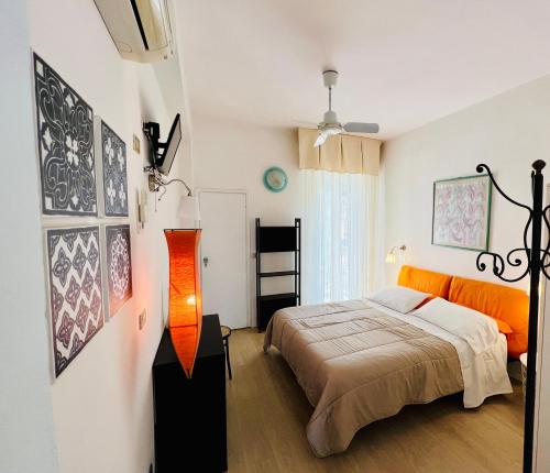 a bedroom with a bed and an orange lamp at B&B Everest Bar Ristorantino in Gabicce Mare