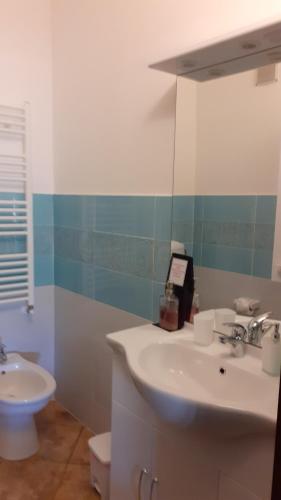 a bathroom with a white sink and a toilet at B&B Il Pizzagiallo in Massa Martana