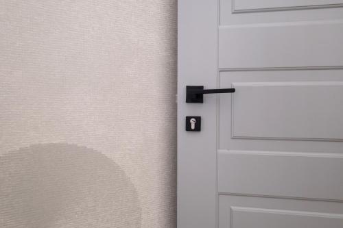 a white door with a black handle on a wall at Dome in Catania