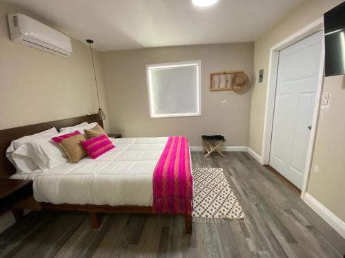 a bedroom with a large bed with pink pillows at Cerrado in El Porvenir