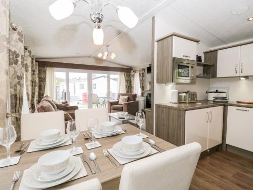 a dining room and kitchen with a table and chairs at Number 10 in Carnforth