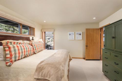 a bedroom with a bed and a dresser and a window at 229 Faraway The Ridge #35 condo in Snowmass Village