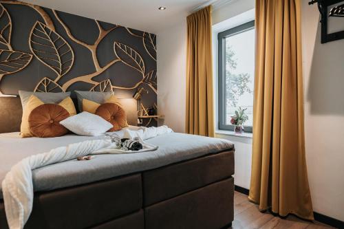 a bedroom with a bed with a dog laying on it at Vida Verde in Valkenburg