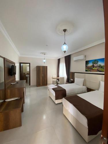 a hotel room with two beds and a television at En Kaya Hotel in North Nicosia
