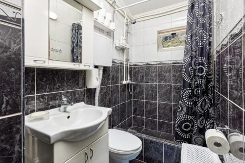 a bathroom with a sink and a toilet and a shower at Vukićević House in Kotor