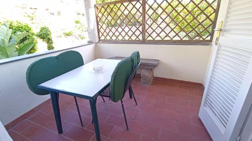 a table and chairs on a balcony with a window at Residence Villa Cristina in Ischia