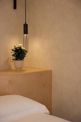 a bedroom with a potted plant sitting on a table at Dome in Catania