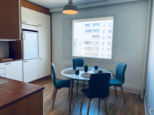 a kitchen and dining room with a table and chairs at STAY Matinkatu Apartment in Espoo