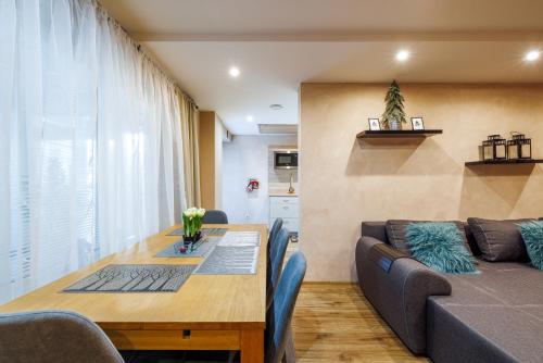 a living room with a table and a couch at Apartman Nosek in Donovaly