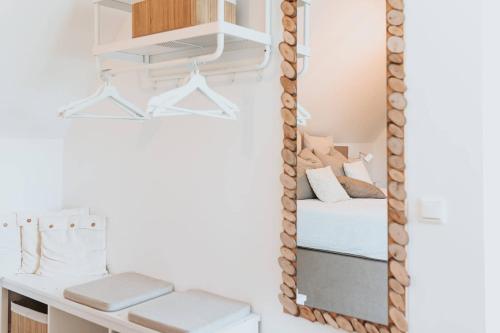 a mirror in a bedroom with a bed and a desk at Vida Verde in Valkenburg