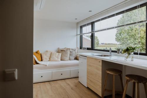 a kitchen with a window bench with pillows on it at Vida Verde in Valkenburg