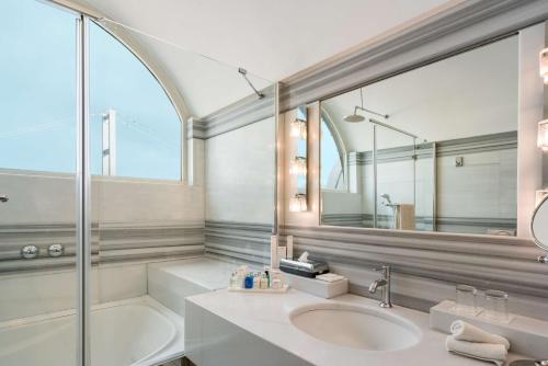 a bathroom with two sinks and a mirror at Radisson Blu Bosphorus Hotel in Istanbul