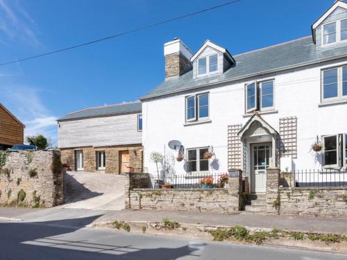 a white house with a stone building at Horsemans Close in Kingsbridge