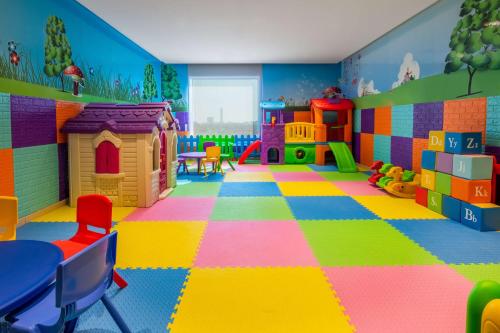 a play room with colorful floors and toys at Park Inn by Radisson Jeddah Madinah Road in Jeddah