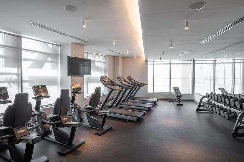 a gym with treadmills and chairs in a room at Park Inn by Radisson Jeddah Madinah Road in Jeddah