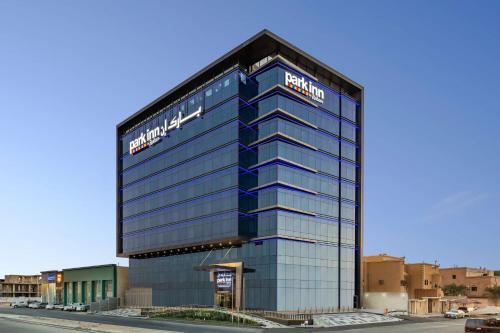 a tall glass building with a santa clara at Park Inn by Radisson Jeddah Madinah Road in Jeddah