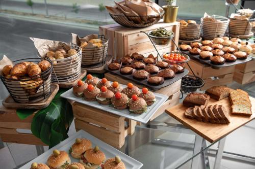 a buffet filled with different types of pastries and pies at Park Inn by Radisson Jeddah Madinah Road in Jeddah