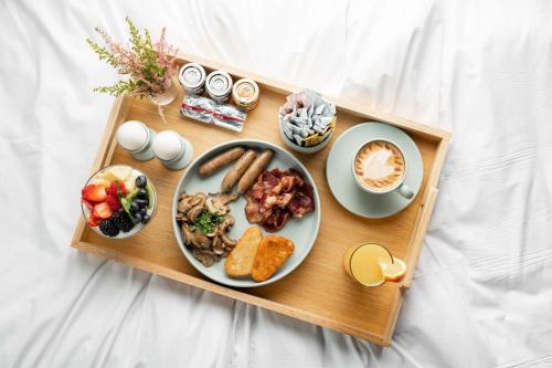 a tray with a plate of food on a table at Park Inn by Radisson Jeddah Madinah Road in Jeddah