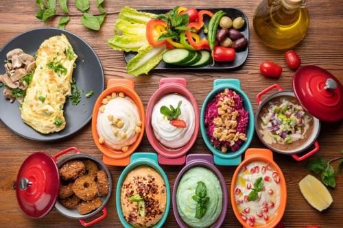 a table with plates of food and bowls of different foods at Park Inn by Radisson Jeddah Madinah Road in Jeddah