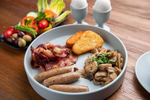 a plate of food with meat and vegetables on a table at Park Inn by Radisson Jeddah Madinah Road in Jeddah