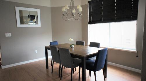 a dining room table with chairs and a chandelier at Modern Luxury Living, relax and enjoy your stay! in Rancho Cordova