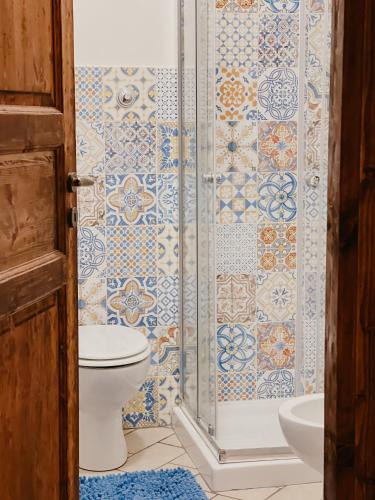 a bathroom with a toilet and a shower at La Casa di Ele in Sutri