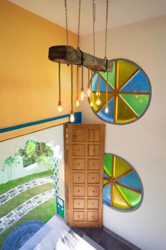 a chandelier hanging from the ceiling in a room at Barefoot Bungalow Hikka in Hikkaduwa