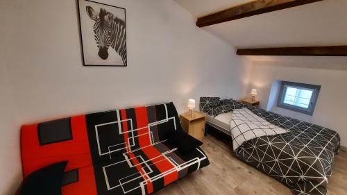 a bedroom with two beds and a picture of a zebra on the wall at Suite 3 pièces chambre+cuisine+SDB centre ville in Privas