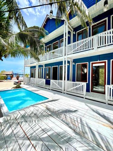 a blue house with a swimming pool in front of it at Marina Sunrise in Holbox Island