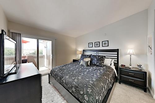 a bedroom with a bed and a desk and a window at Monarch Vista in Dana Point