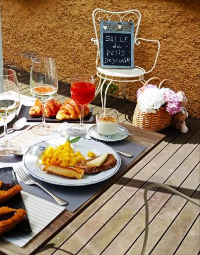 a table with a plate of food and glasses of wine at Hotel Sant'Andrea in Santa Margherita Ligure