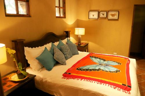 a bedroom with a bed with a colorful blanket on it at 3 Architectural Homes, Wi-fi and Pool in Lagunillas