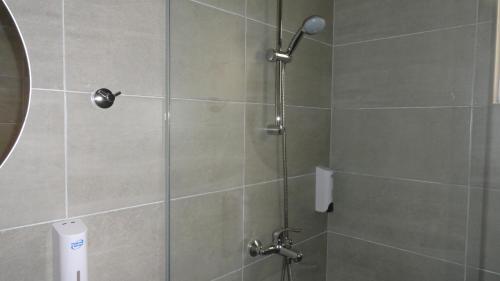 a bathroom with a shower with a glass door at Afroditi Hotel in Plakias