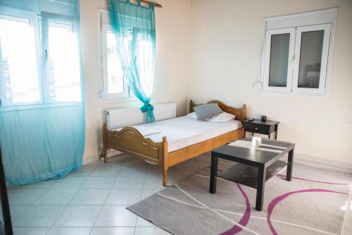 a small bedroom with a bed and a table at Ira's House in Tríkala
