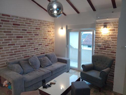 a living room with a couch and two chairs at Budva stan Natasa in Budva