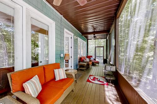 a porch with an orange couch on a house at The Dawg Pound in Maynardville